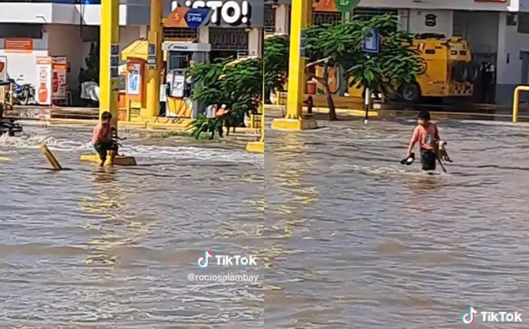 Niño cruzando calle inundada