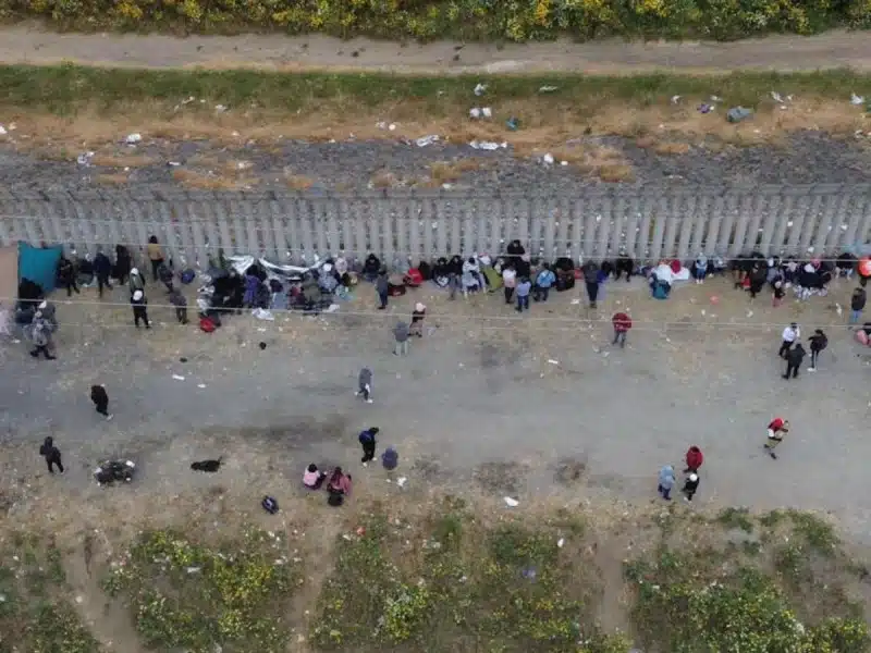 ¡Conmovedor! Captan a migrantes que duermen al lado del muro fronterizo en Tijuana