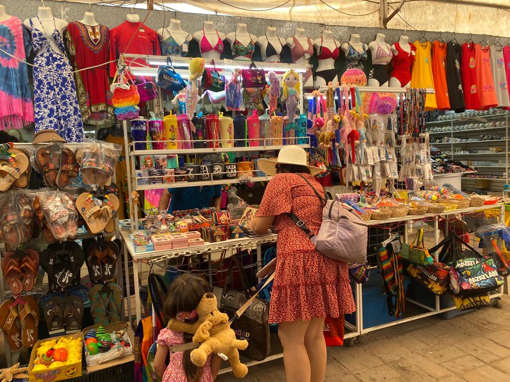 Cliente observando mercancía en un puesto de souvenirs