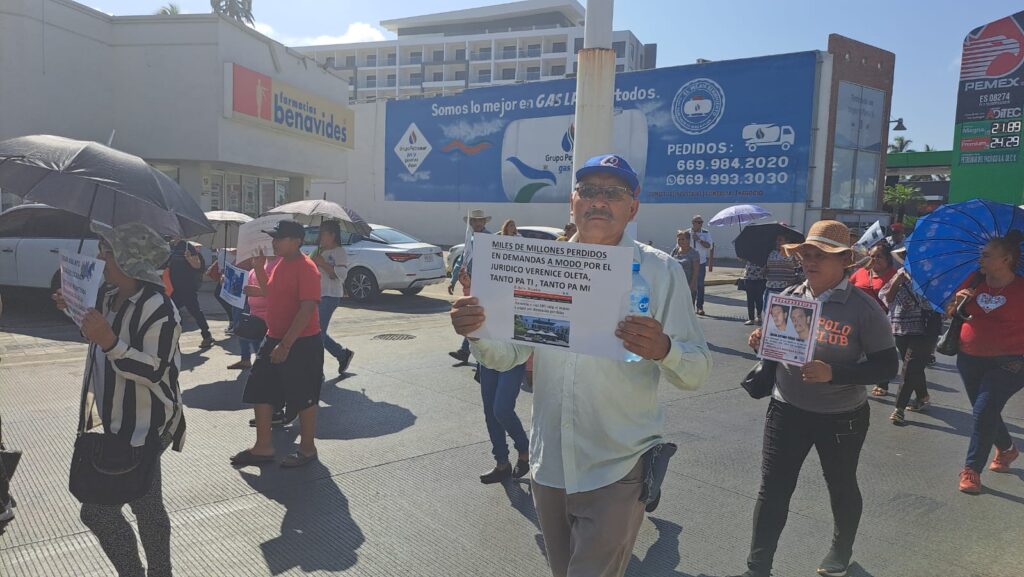 Con gorras sombreros sombrillas y demás se manifiestan ciudadanos por las calles de Mazatlán