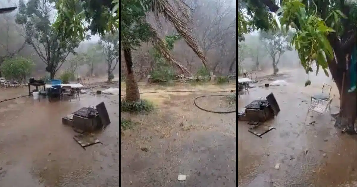 Lluvia mojando la tierra a las afueras de una vivienda