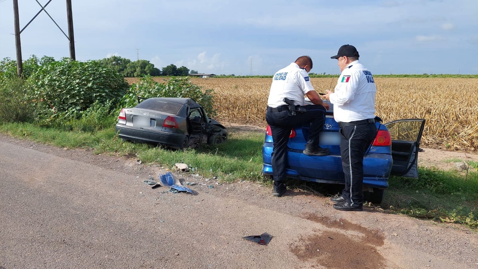 2 carros chocados y 2 personas con uniforme de Tránsito Municipal