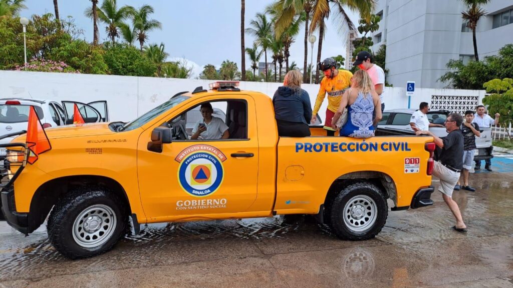 Vehículo de Protección Civil subiendo a personas afectadas por las lluvias