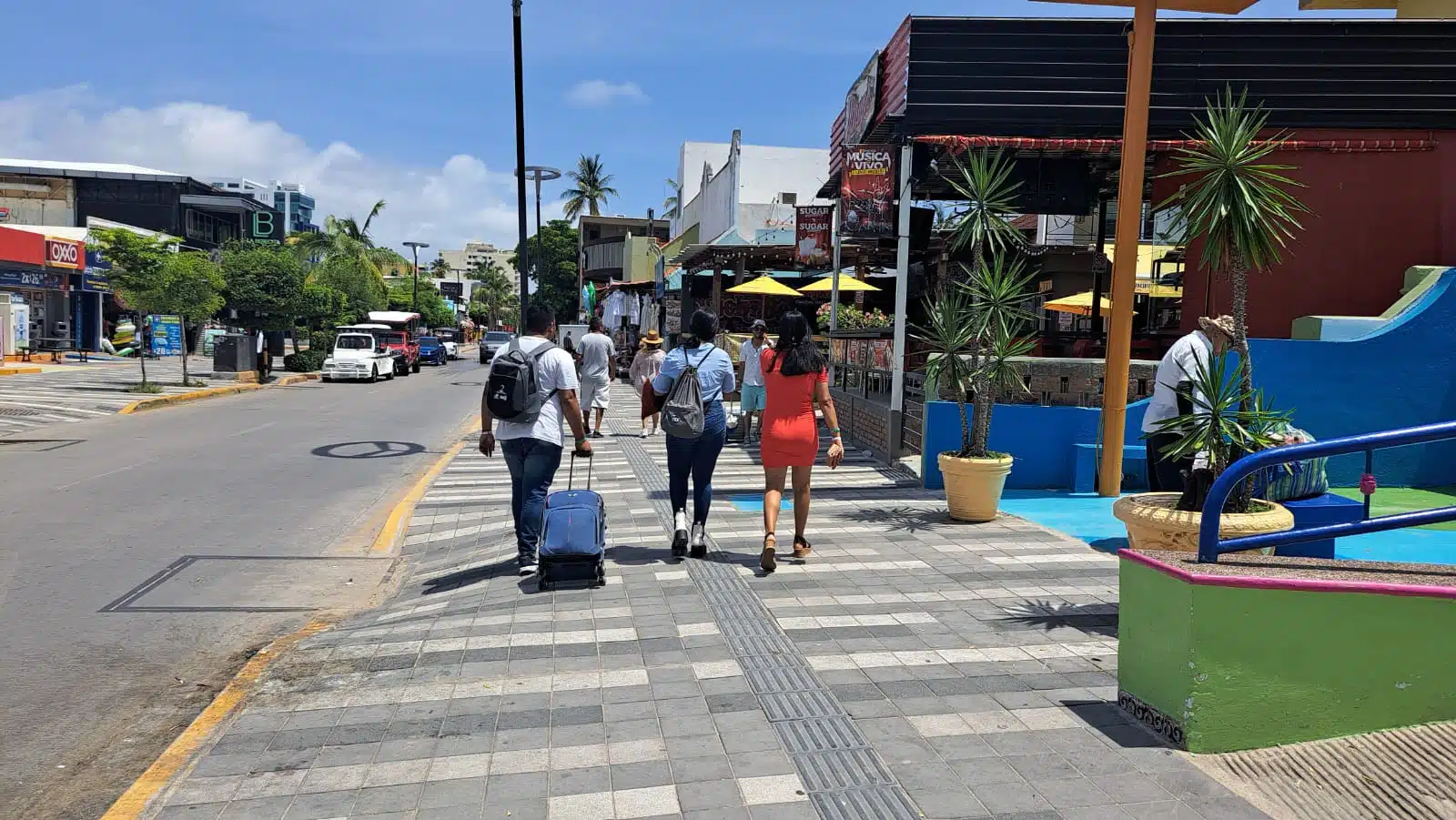 Turistas con maleta en calles de Mazatlán