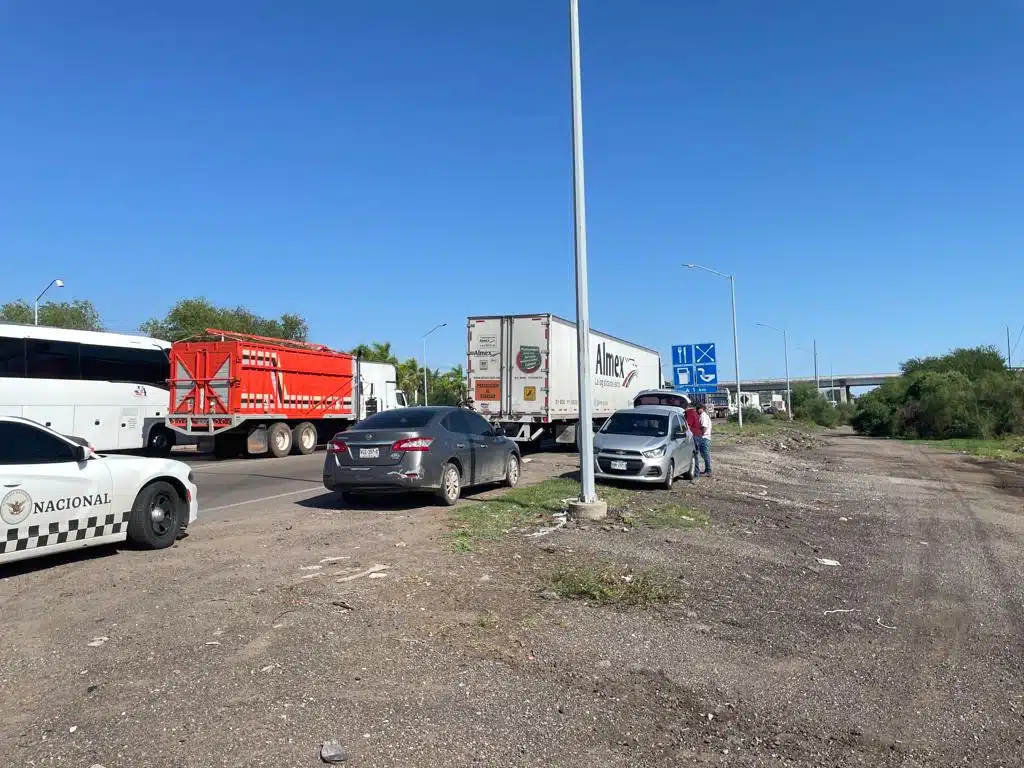 Automóviles y tráileres detenidos por la carretera México 15. Hay presencia de la Guardia Nacional