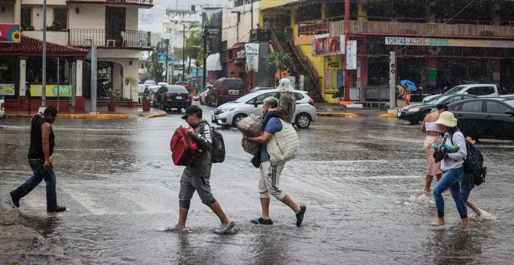 Personas corriendo con maletas en la lluvia