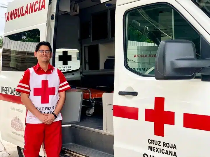 Paramédico de Cruz Roja junto a una ambulancia