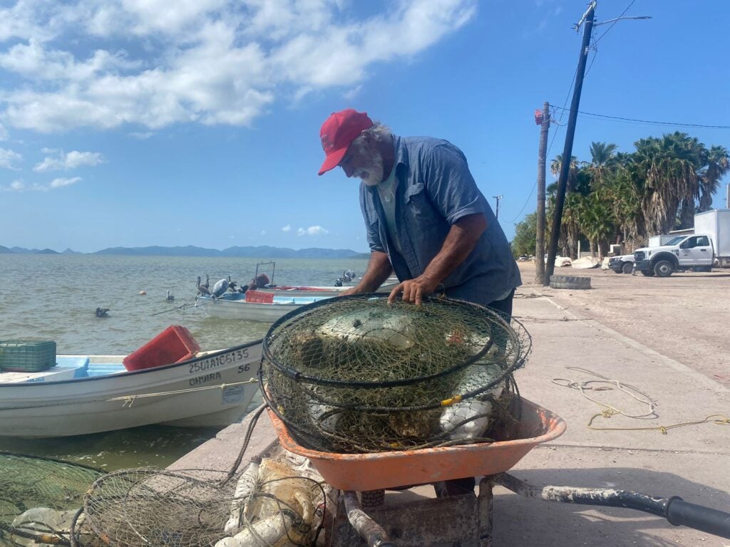 Pescador llevando sus pertenencias en una carreta