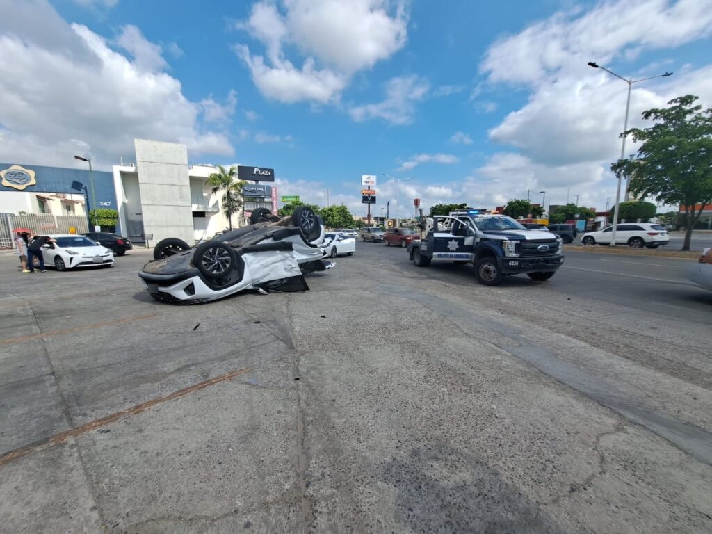 Camioneta volcada con los neumáticos hacia arriba y a un lado un carro chocado