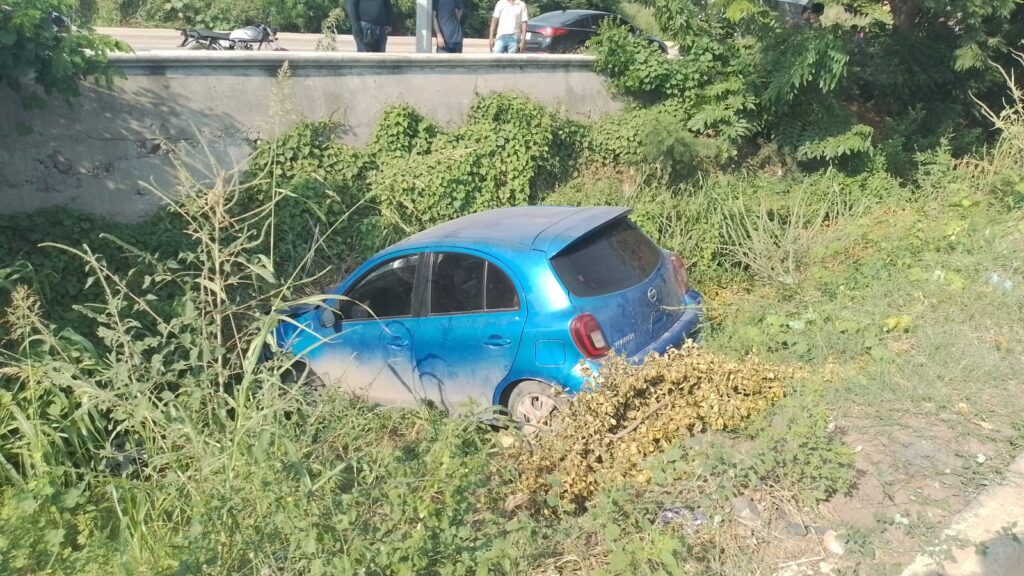 Auto Nissan March azul en un canal tras accidente en Mazatlán