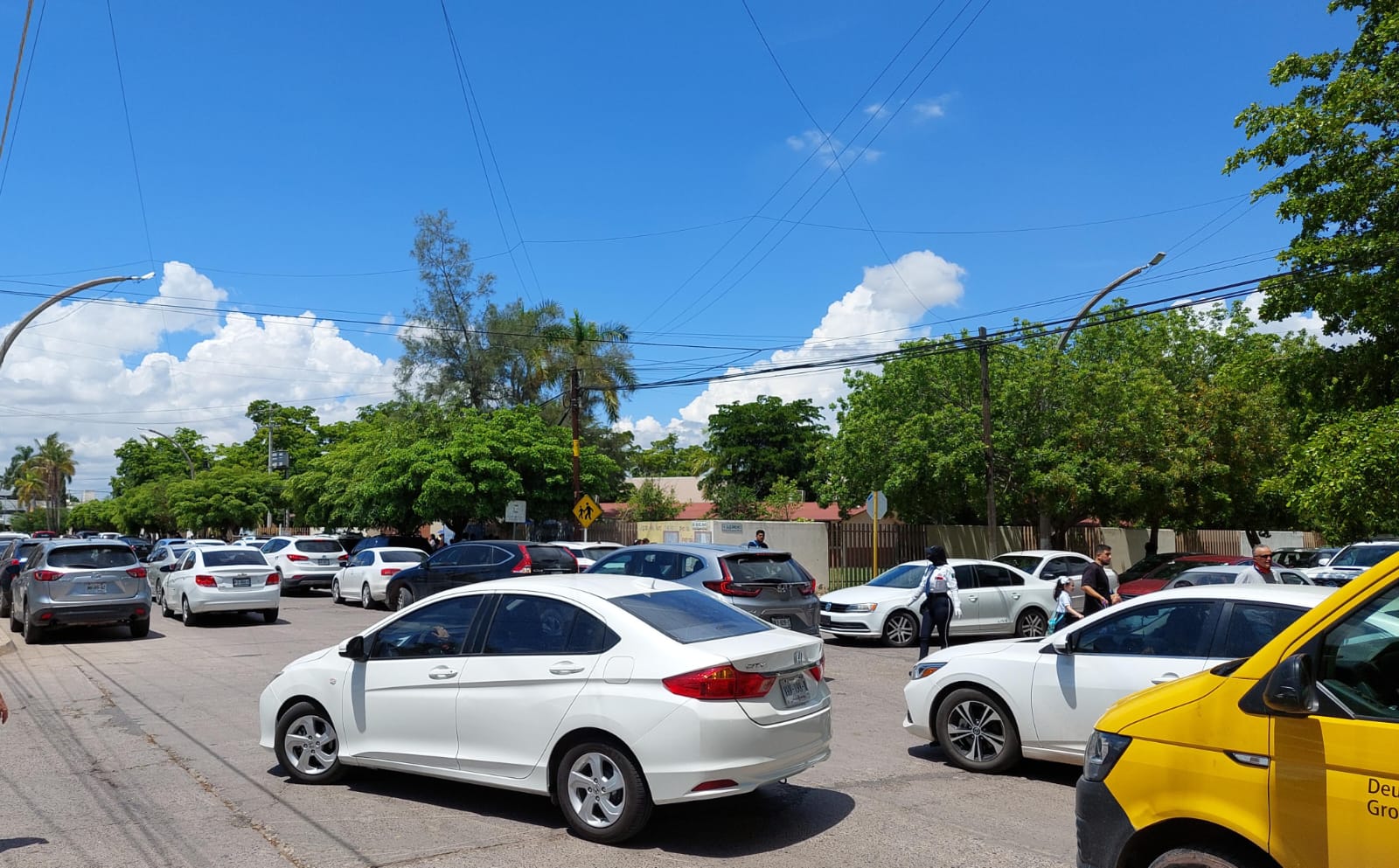 Autos en doble fila afuera de escuelas de Los Mochis