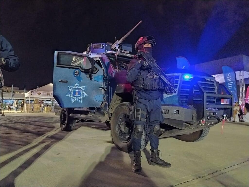 Elementos de la Policía Estatal armados. atrás carro blindado