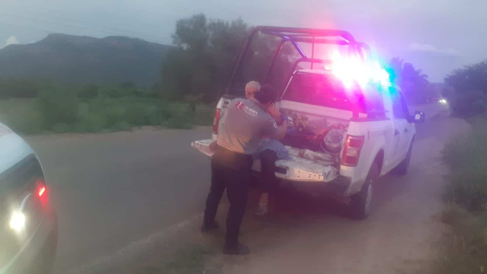 Personal de protección civil atendiendo a adulto mayor en camioneta de la policía municipal.