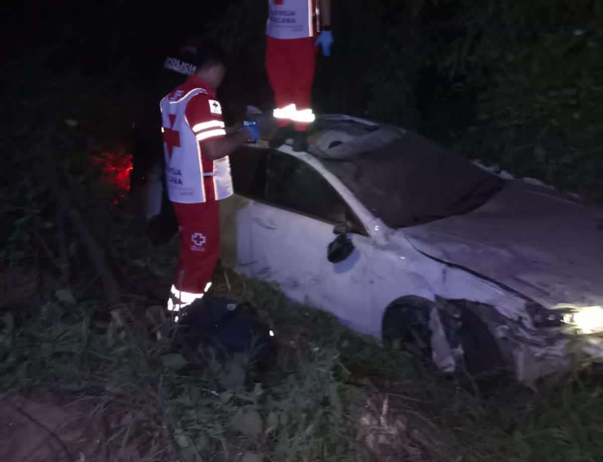 Socorrista revisando automóvil accidentado abandonado