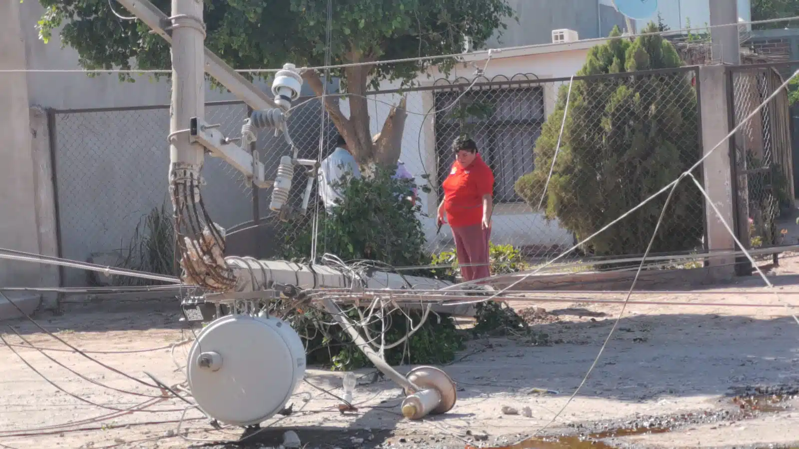 Poste de electricidad derribado sobre la calle