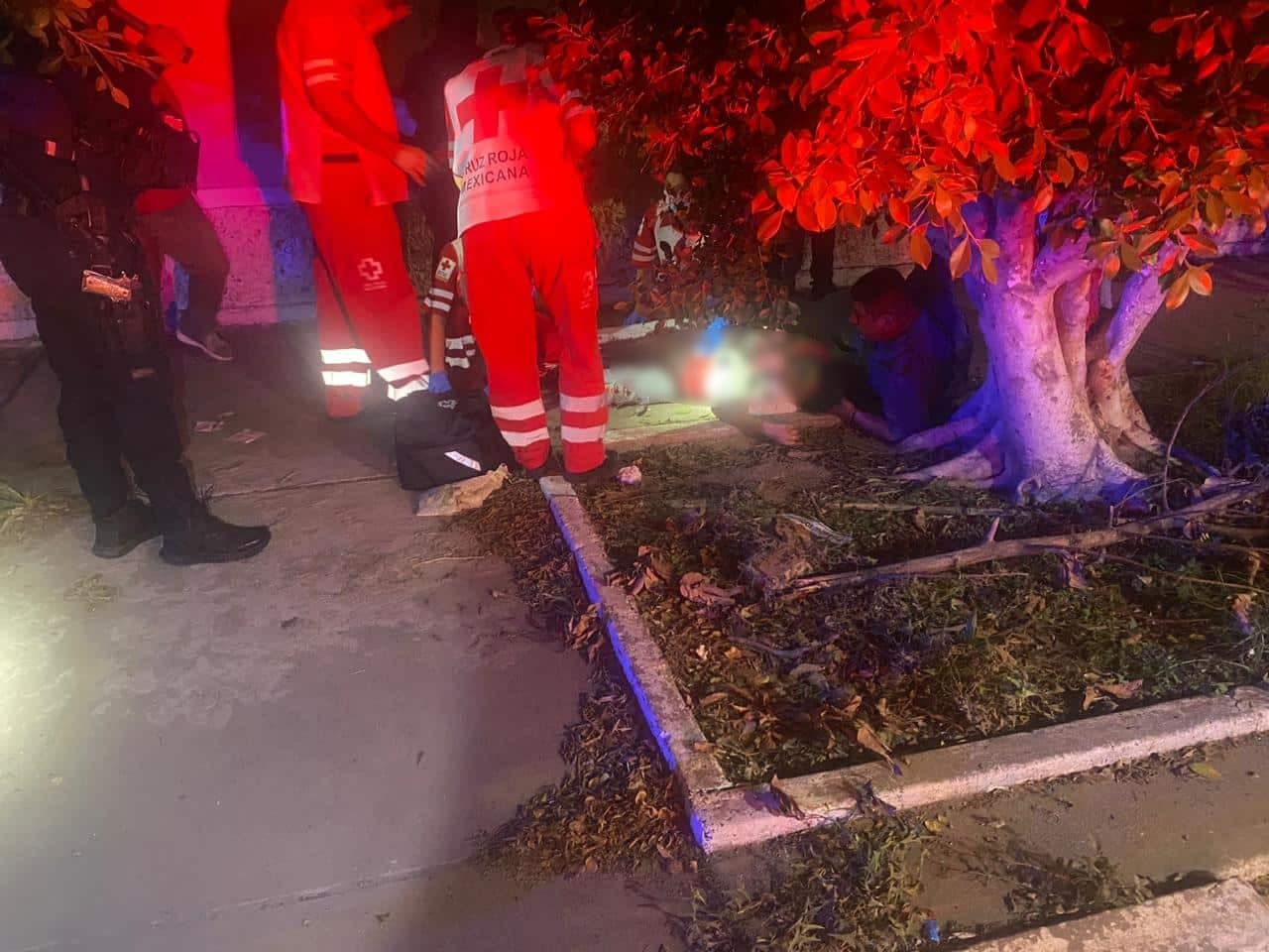 Mujer en el suelo con paramédicos alrededor