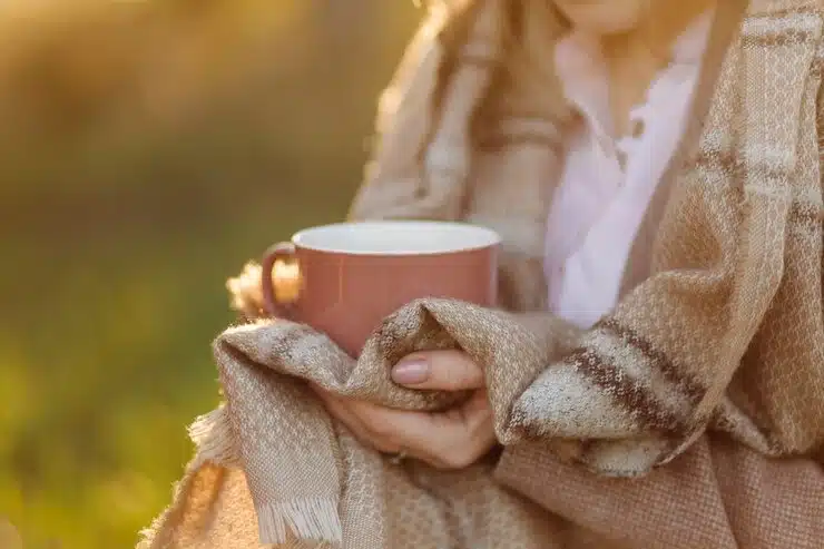 Mujer sosteniendo taza caliente