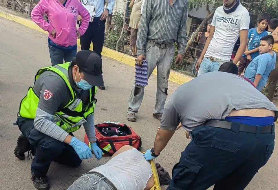 Hombre en el suelo tras caer en su motocicleta. Es auxiliado por paramédicos y población de Higuera de Zaragoza, Ahome
