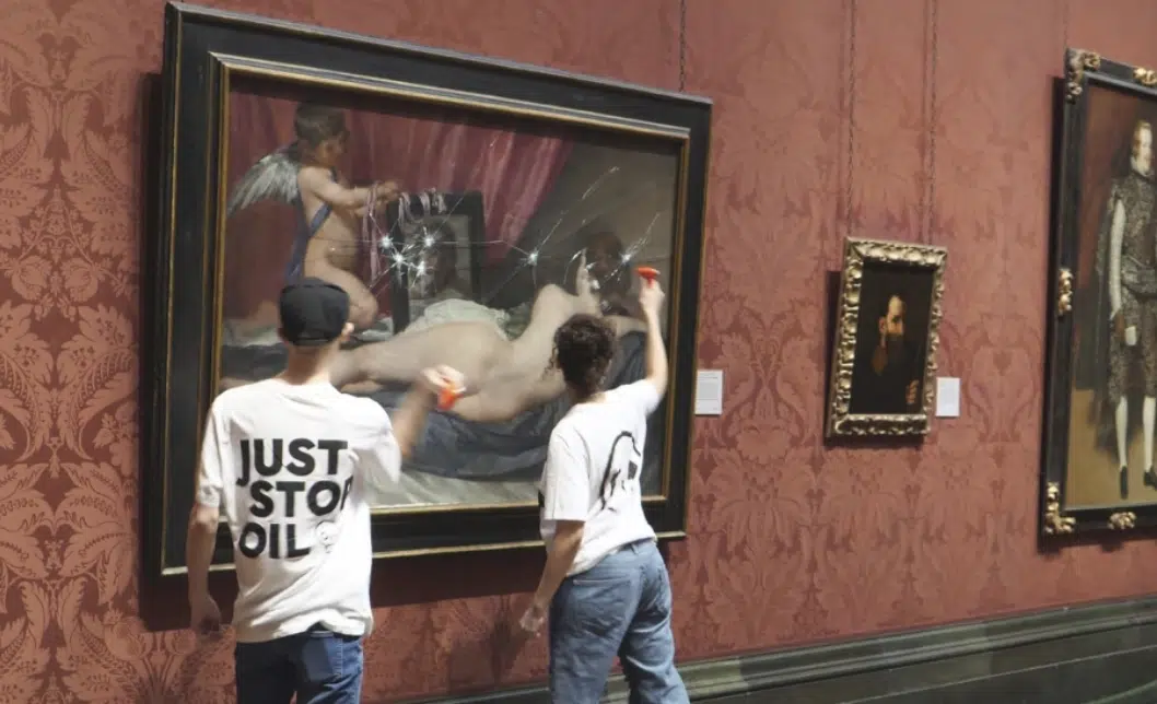 Activistas golpean el vidrio protector de una pintura