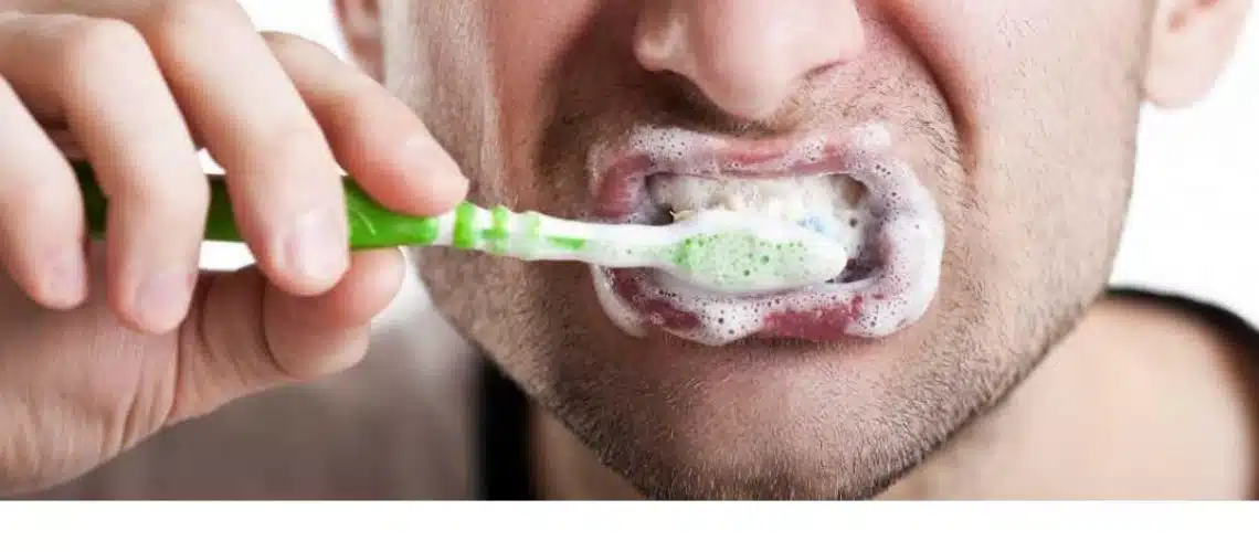 Persona lavándose los dientes