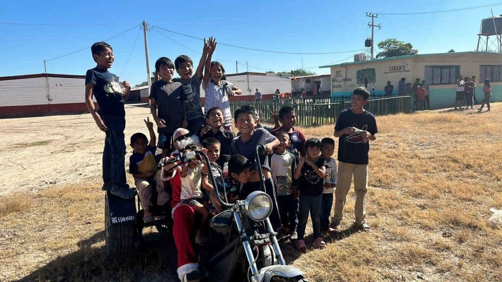 Niños felices con motociclista en el Motoclos 2023