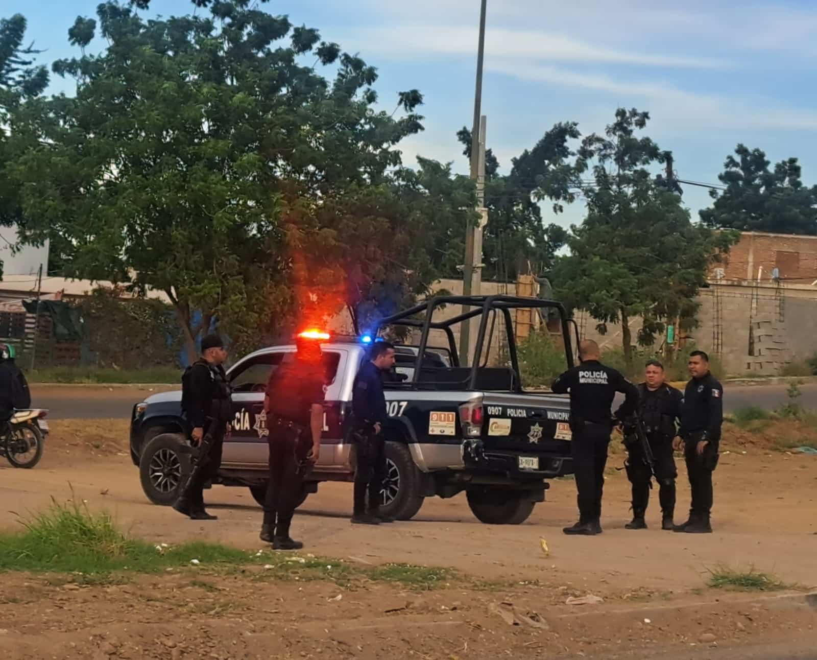 Camioneta y policías municipales estacionados en la calle