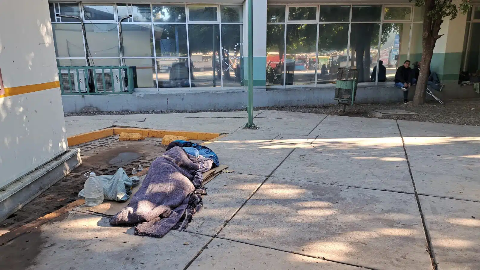 Persona durmiendo en el piso, afuera del Hospital General de Los Mochis