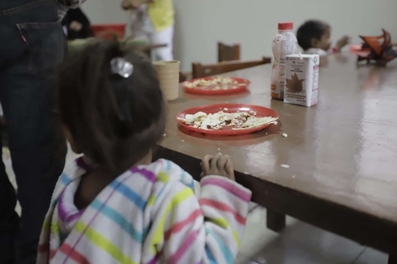 Niña disfrutando de un desayuno en la guardería
