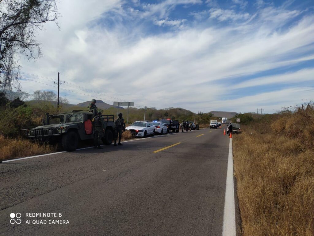 Elementos de la Policía Estatal, Militares y Guardia Nacional en el lugar donde encontraron el cuerpo de un hombre sin vida envuelto en hule negro a un lado de la carretera en San Ignacio