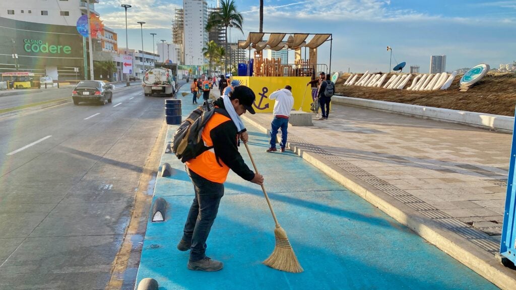 Trabajador de Aseo Urbano barre el malecón de Mazatlán