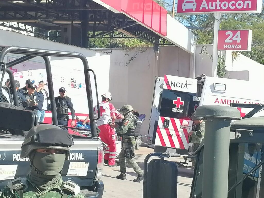 Paramédicos de Cruz Roja llevando al joven lesionado en una camilla hacia la ambulancia