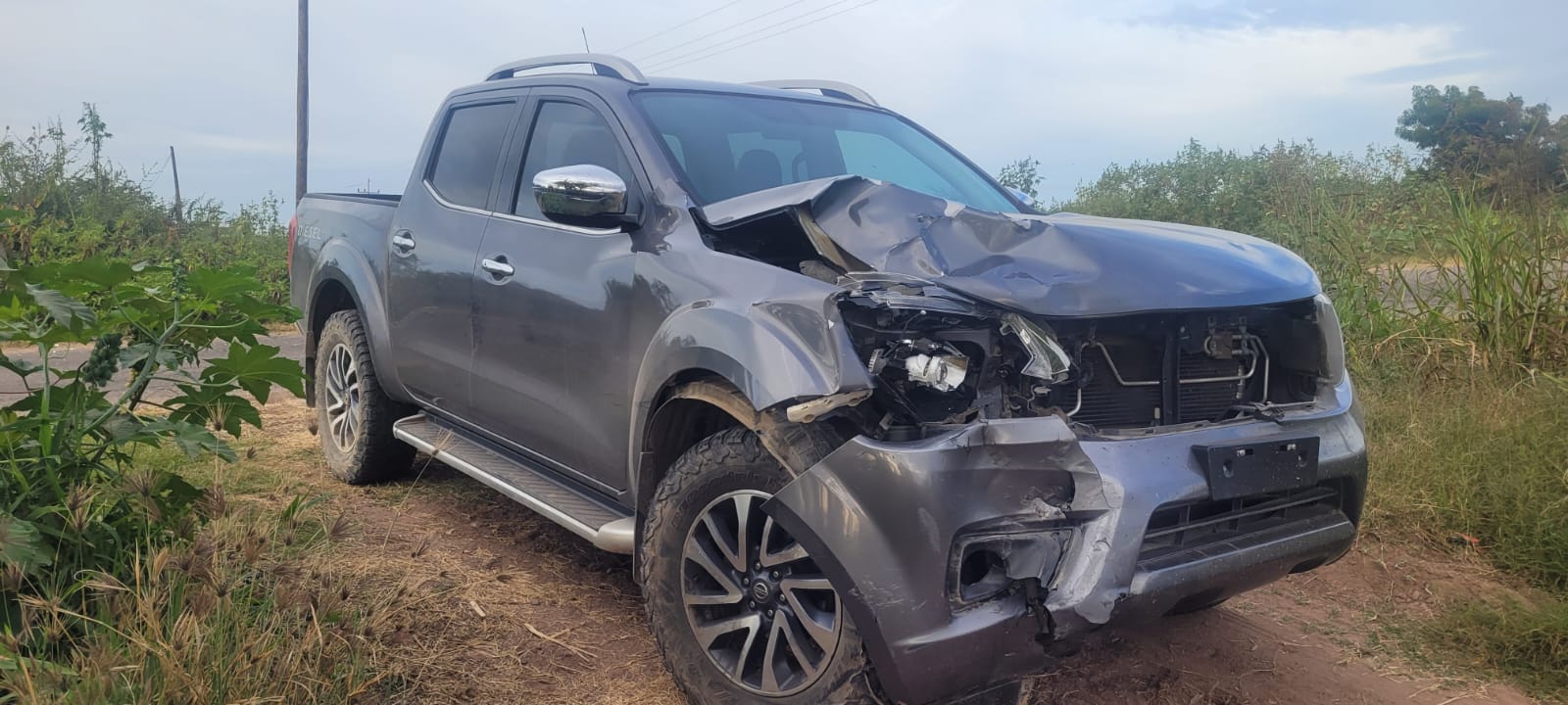 Camioneta tipo Toyota Tacoma gris accidentada.