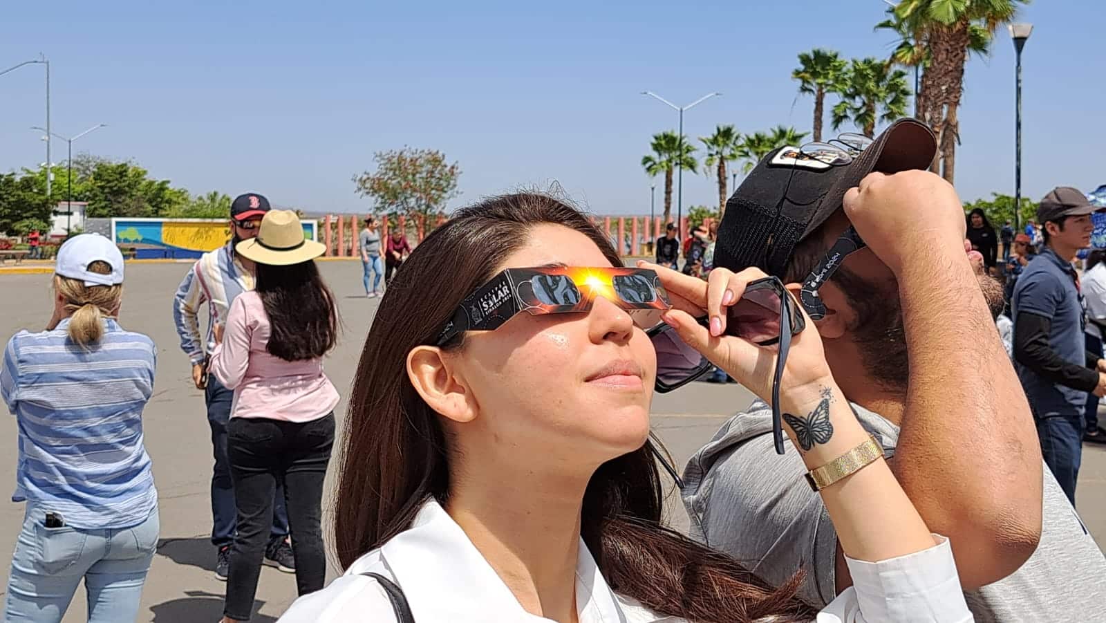 Personas en la presa Eustaquio Buelna mirando al cielo para apreciar el eclipse total de Sol en Guamúchil