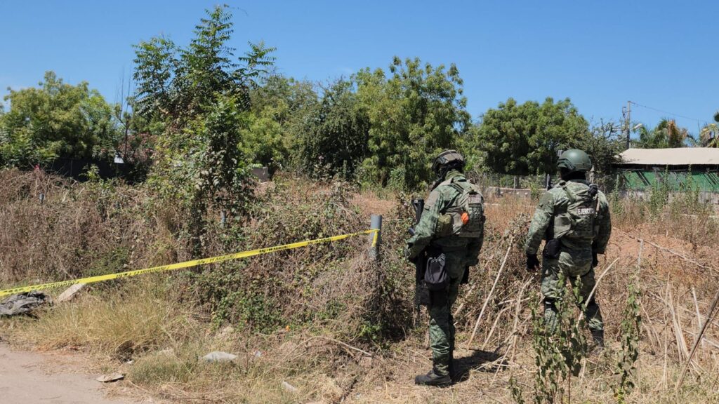 Elemento del Ejército en zona delimitada con cinta amarilla donde se localiza cuerpo sin vida, en Culiacán
