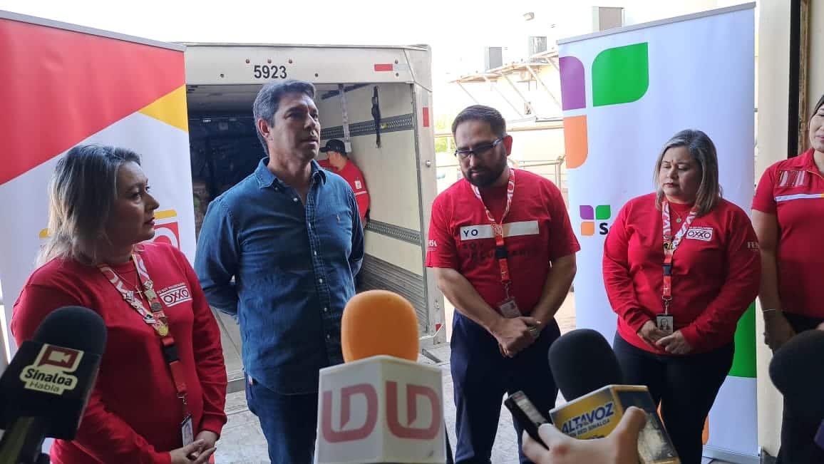 Personal de oxxo atendiendo entrevista respecto a la donación de alimentos