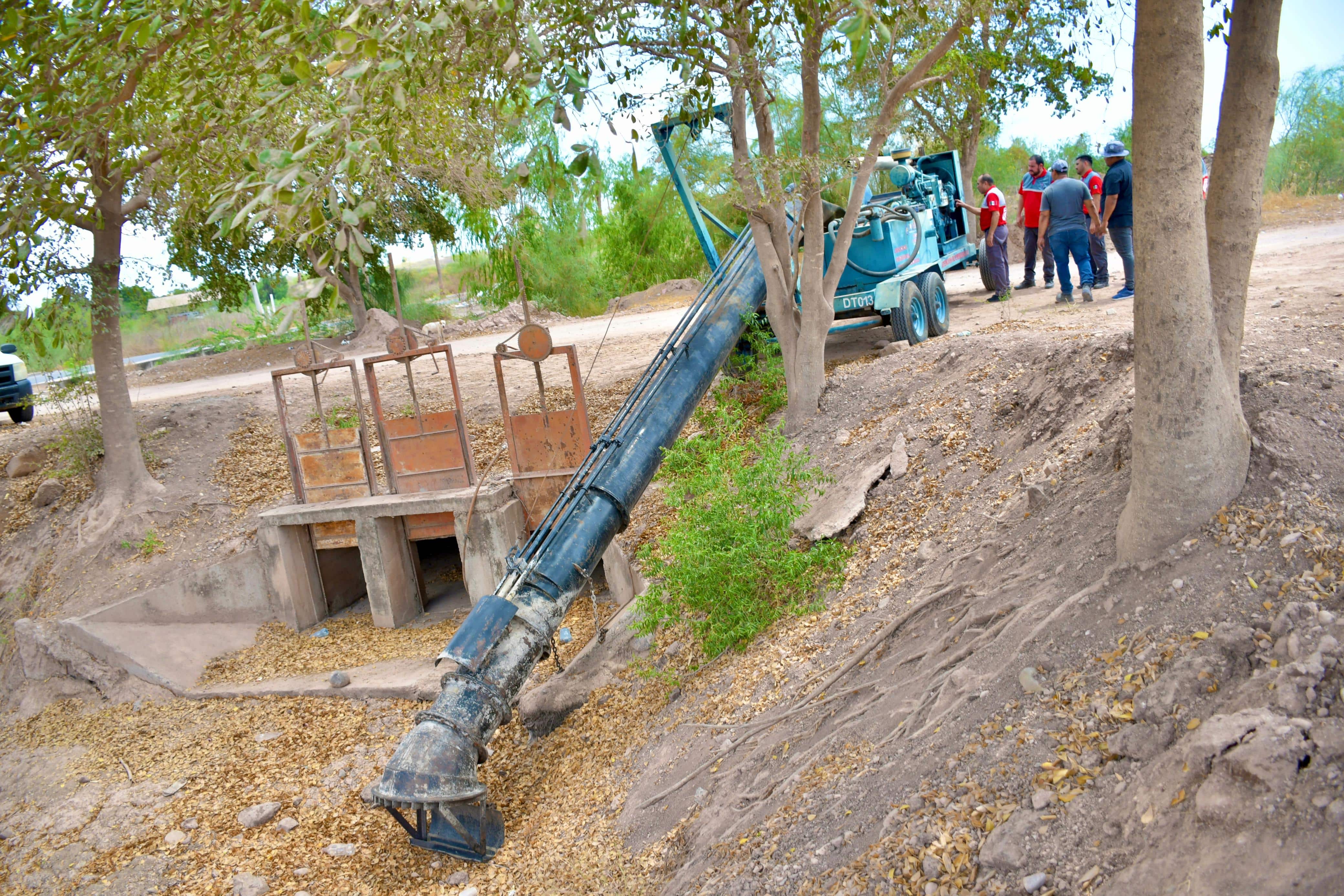 Elementos de Protección Civil instalando bombas de succión en la colonia Las Garzas en Guamúchil