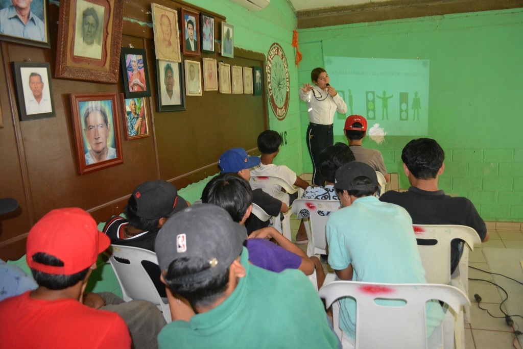 Agente municipal hablando a jóvenes