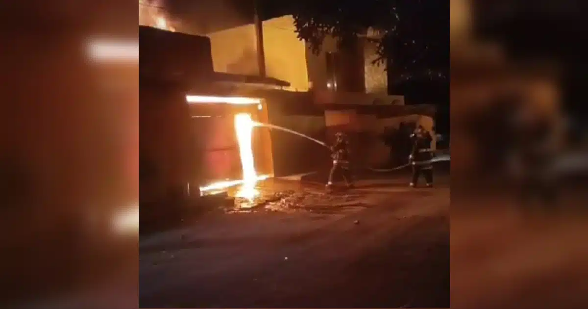 Bomberos combatiendo el incendio en la vivienda de 