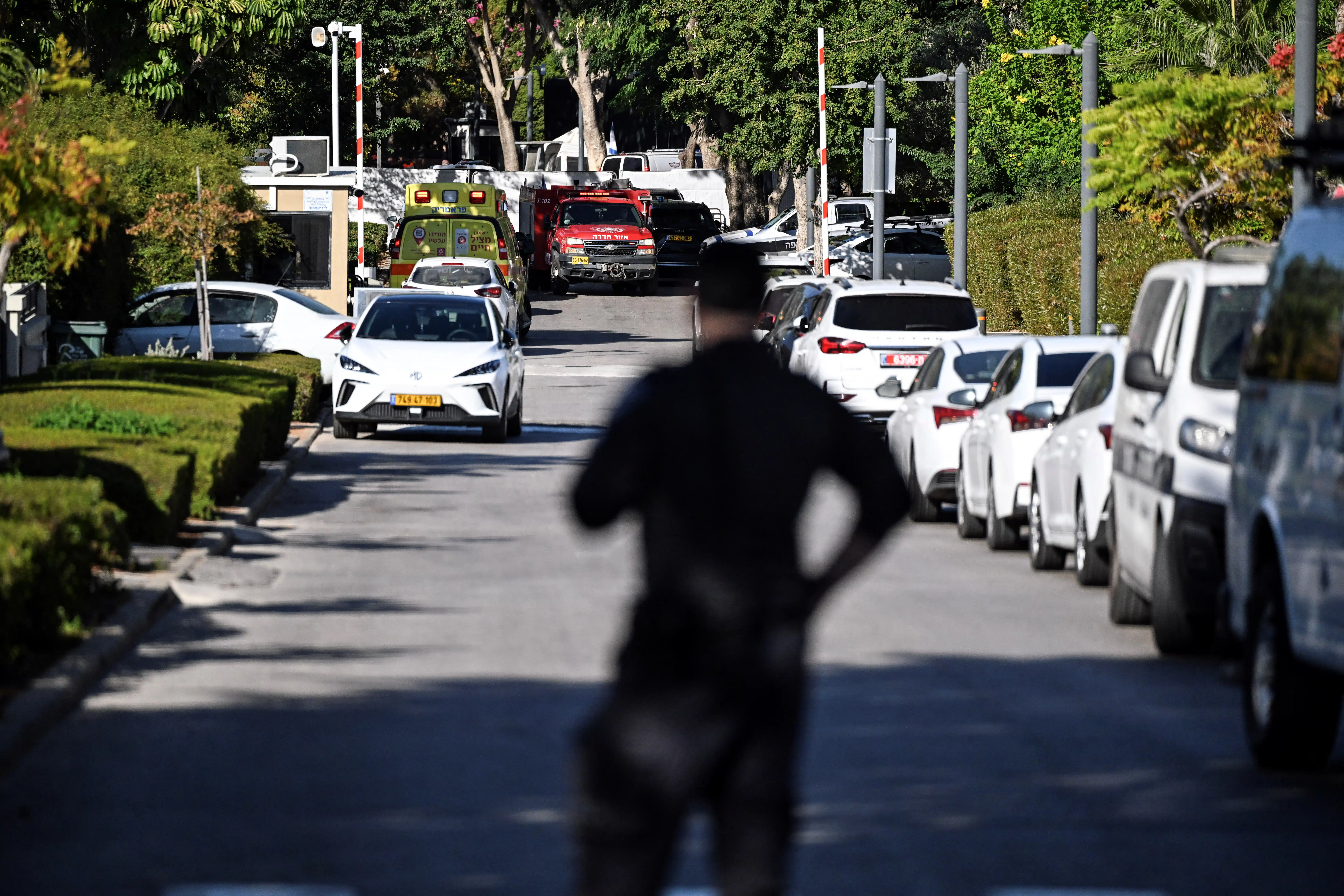 A member of Israeli security personnel stands at the entrance to a street, following a drone attack from Lebanon towards Israel amid ongoing hostilities between Hezbollah and Israel, in Caesarea