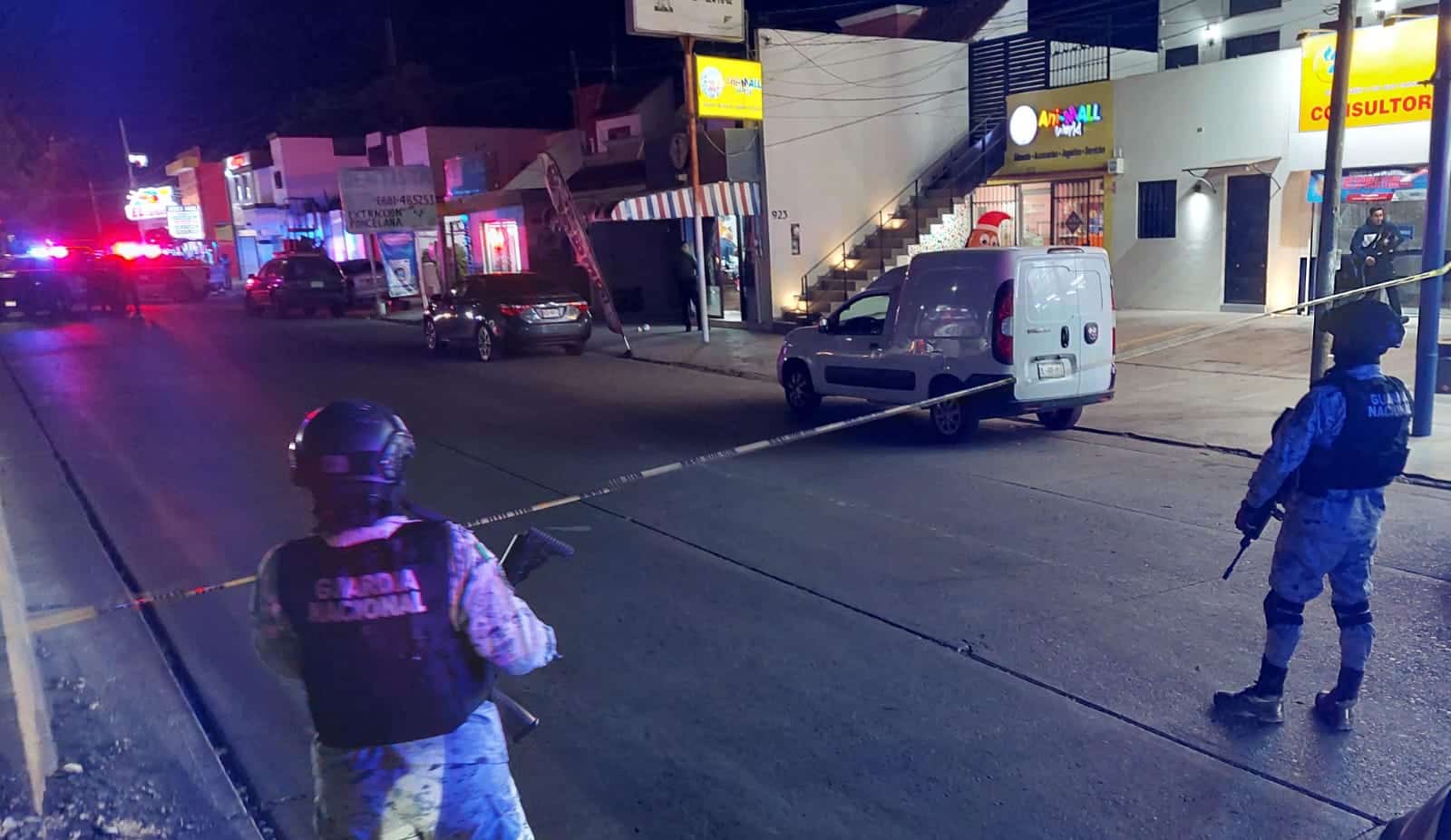 Agentes de seguridad resguardando la zona acordonada en donde se registró el asesinato a balazos.