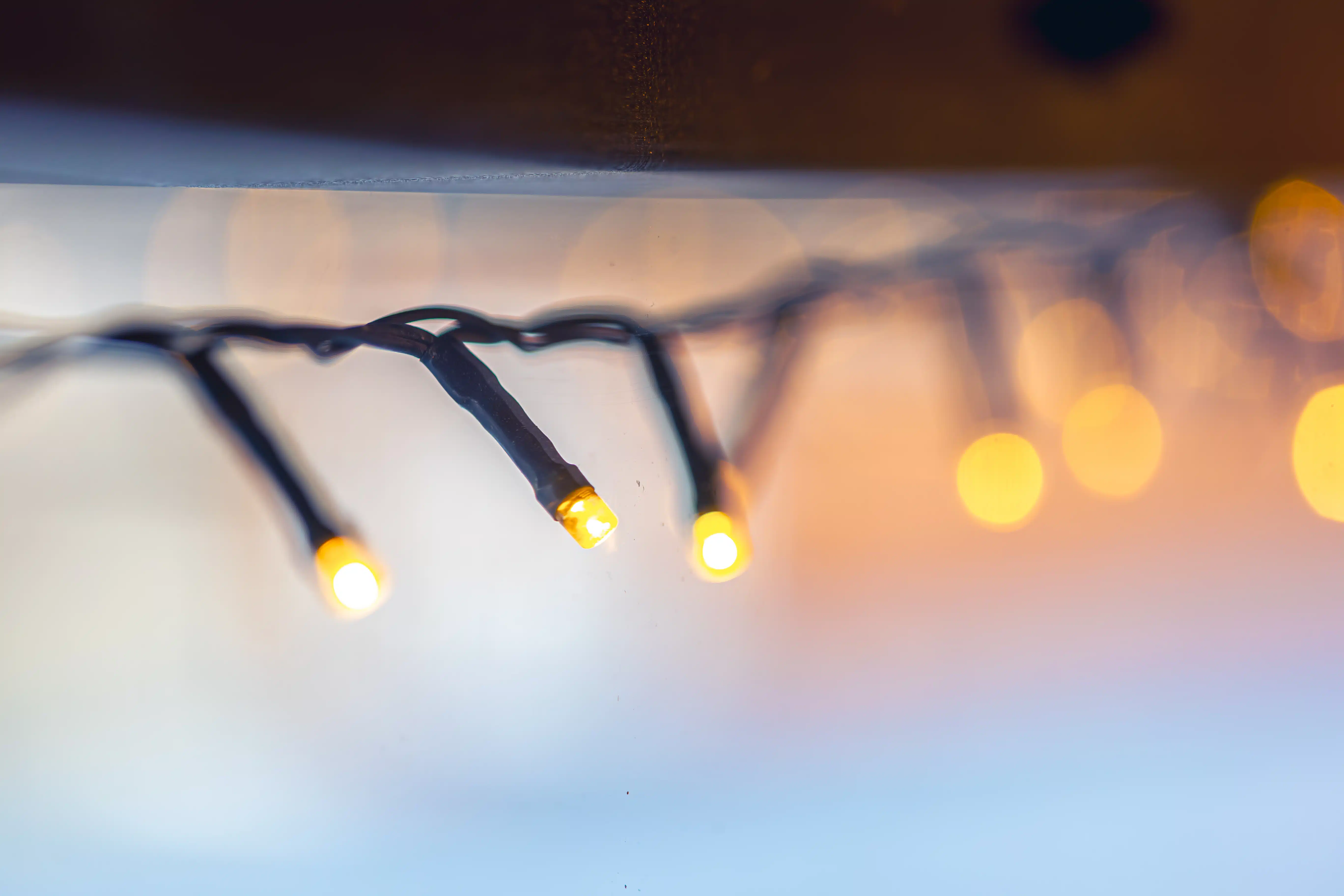 Macro shot of a glowing garland on a blurred background with bokeh.