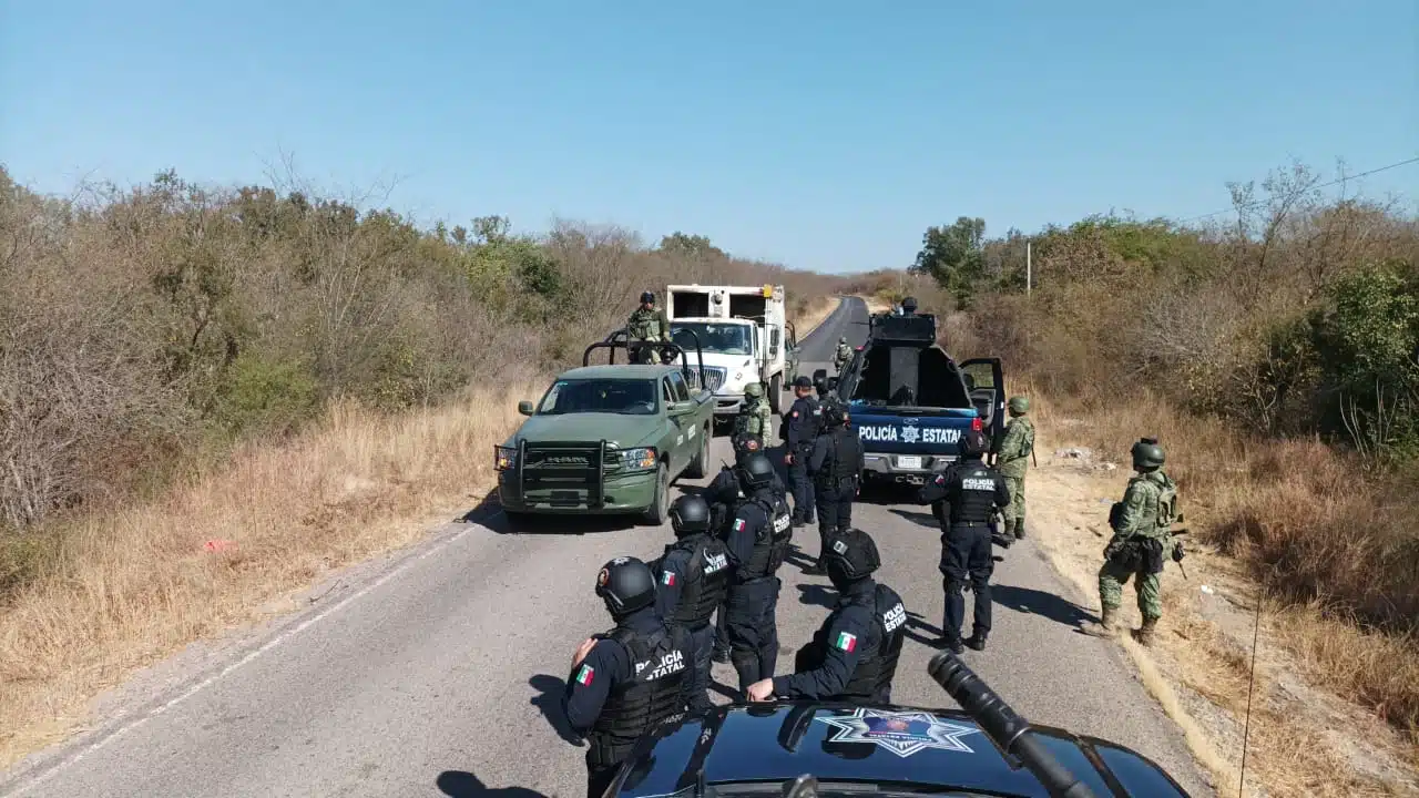 Militares y policías estatales asegurando los camiones recolectores de basura que fueron sustraídos.