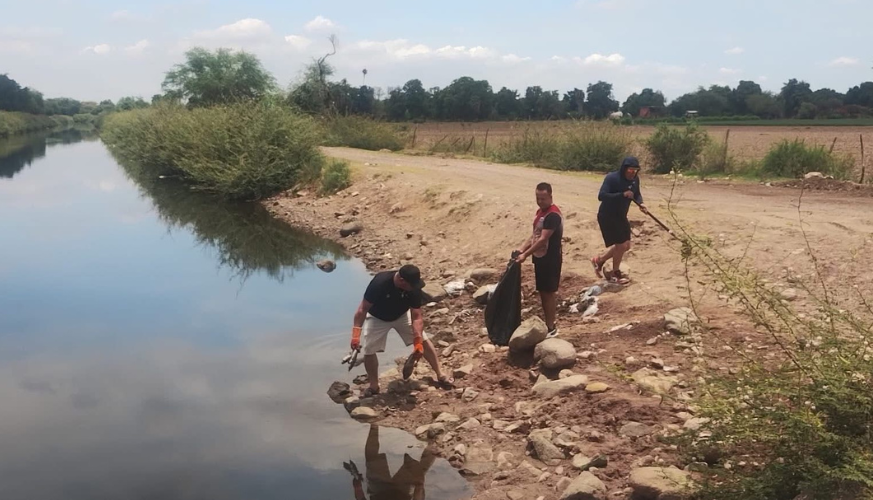 Personas sacan peces muertos del canal Cahuinahua
