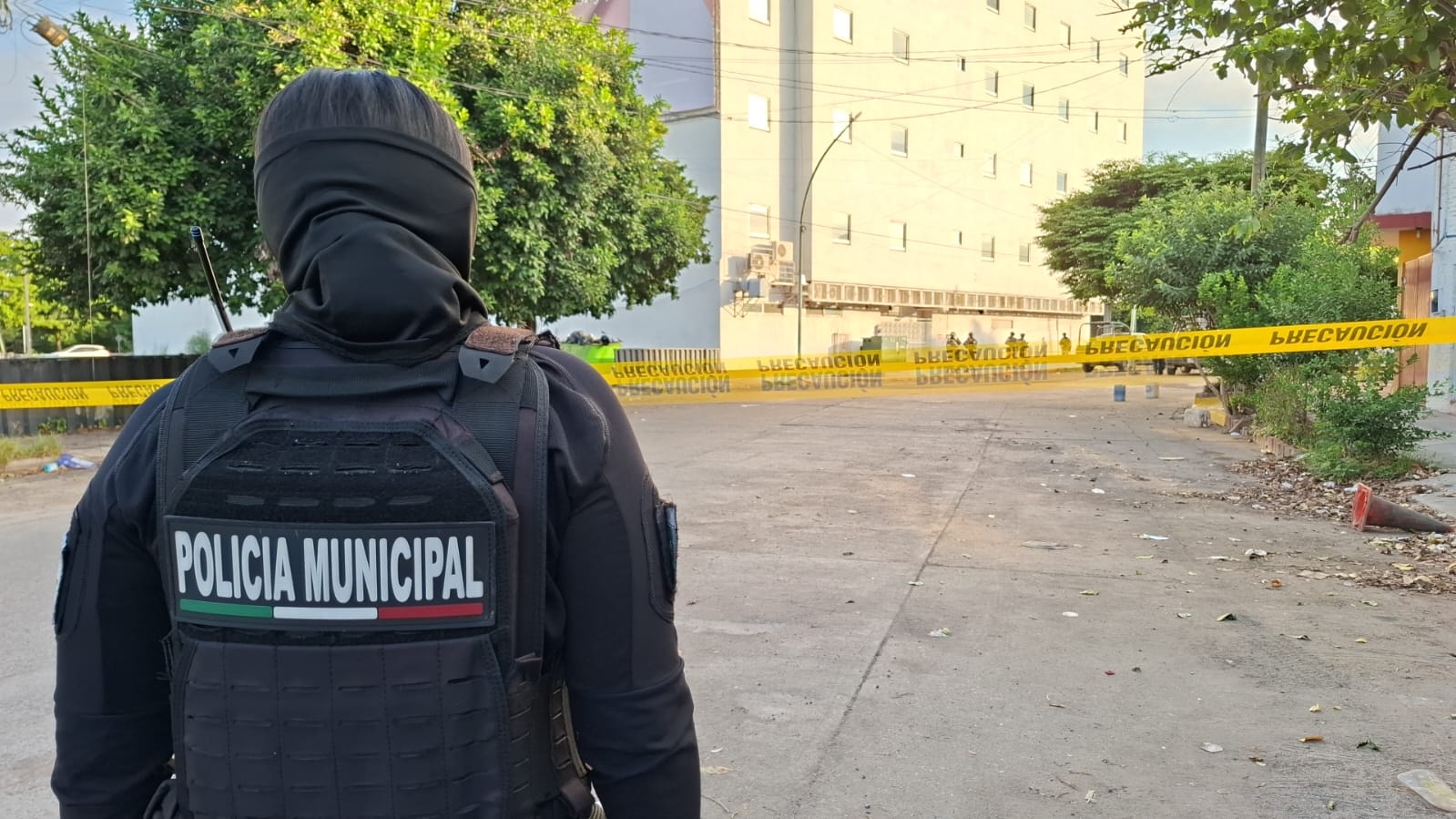Policía Municipal de espaldas frente a una cinta amarilla