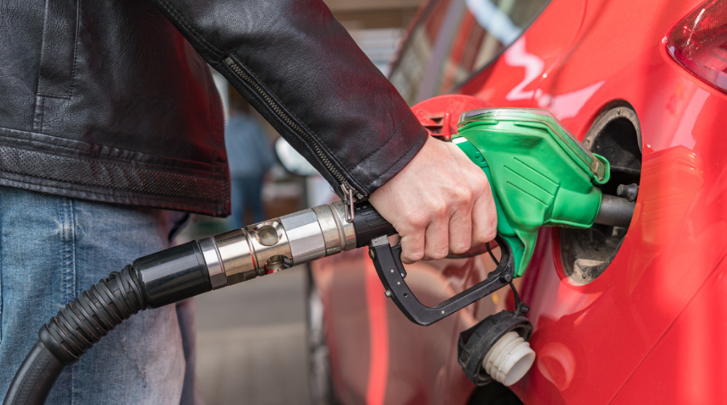 Manguera de gasolina color verde en una estación de servicio, aparecen dos cuadros uno de color verde (gasolina Magna) y el otro recuadro es rojo (gasolina Premium)