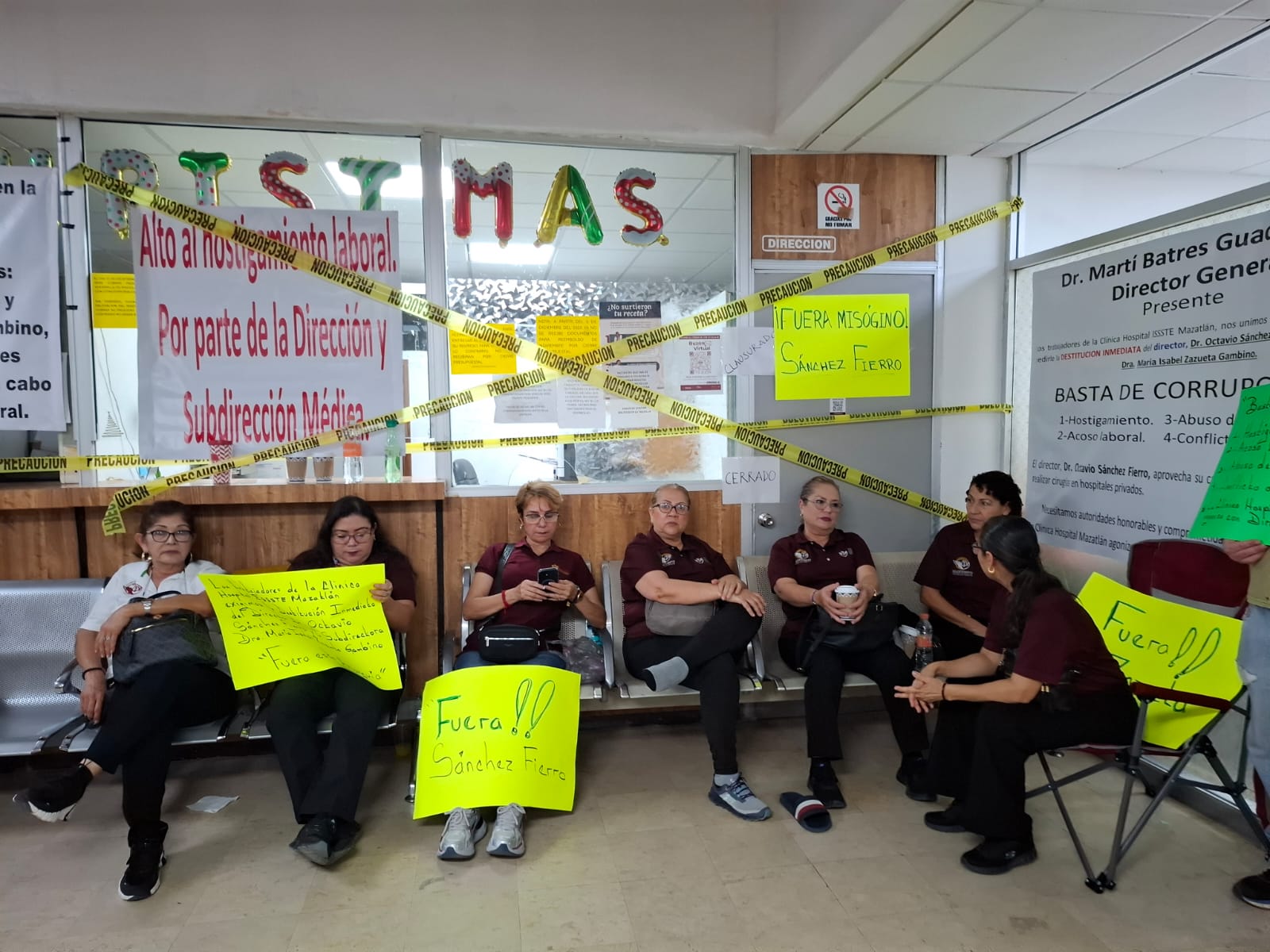 Personas con pancartas sentadas manifestándose
