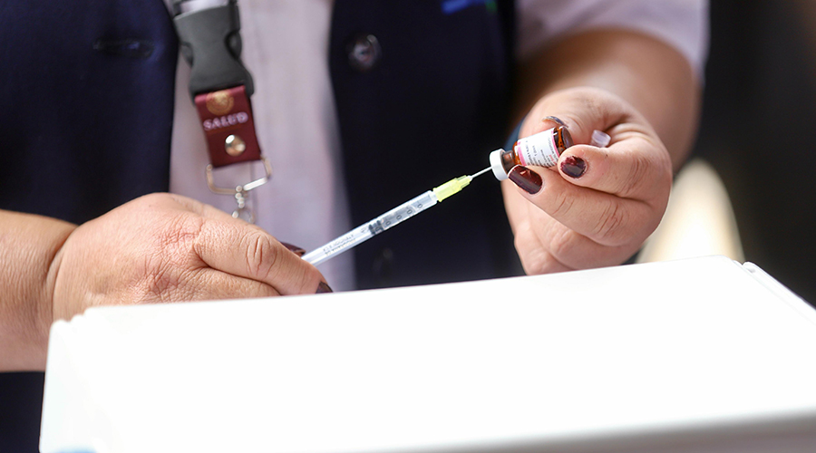 Personal de salud prepara vacuna para ser aplicada
