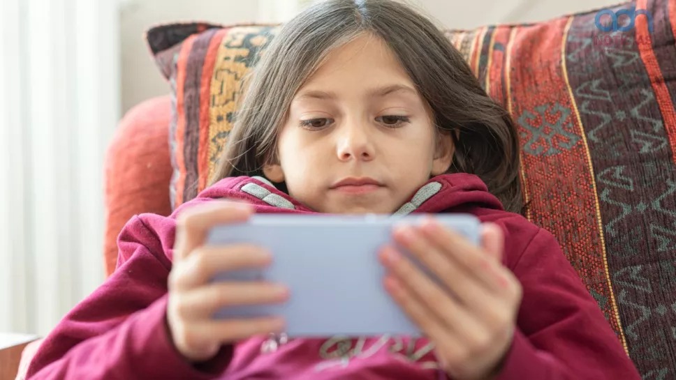 niñla sentada viendo redes sociales