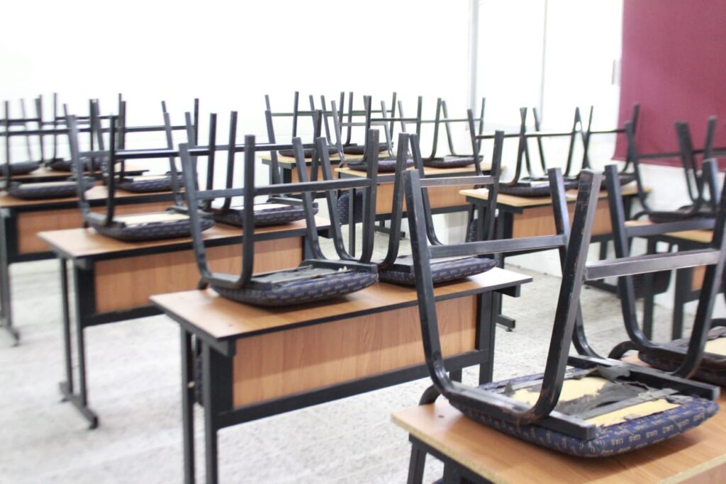 Sillas y escritorios en salón de la UAS