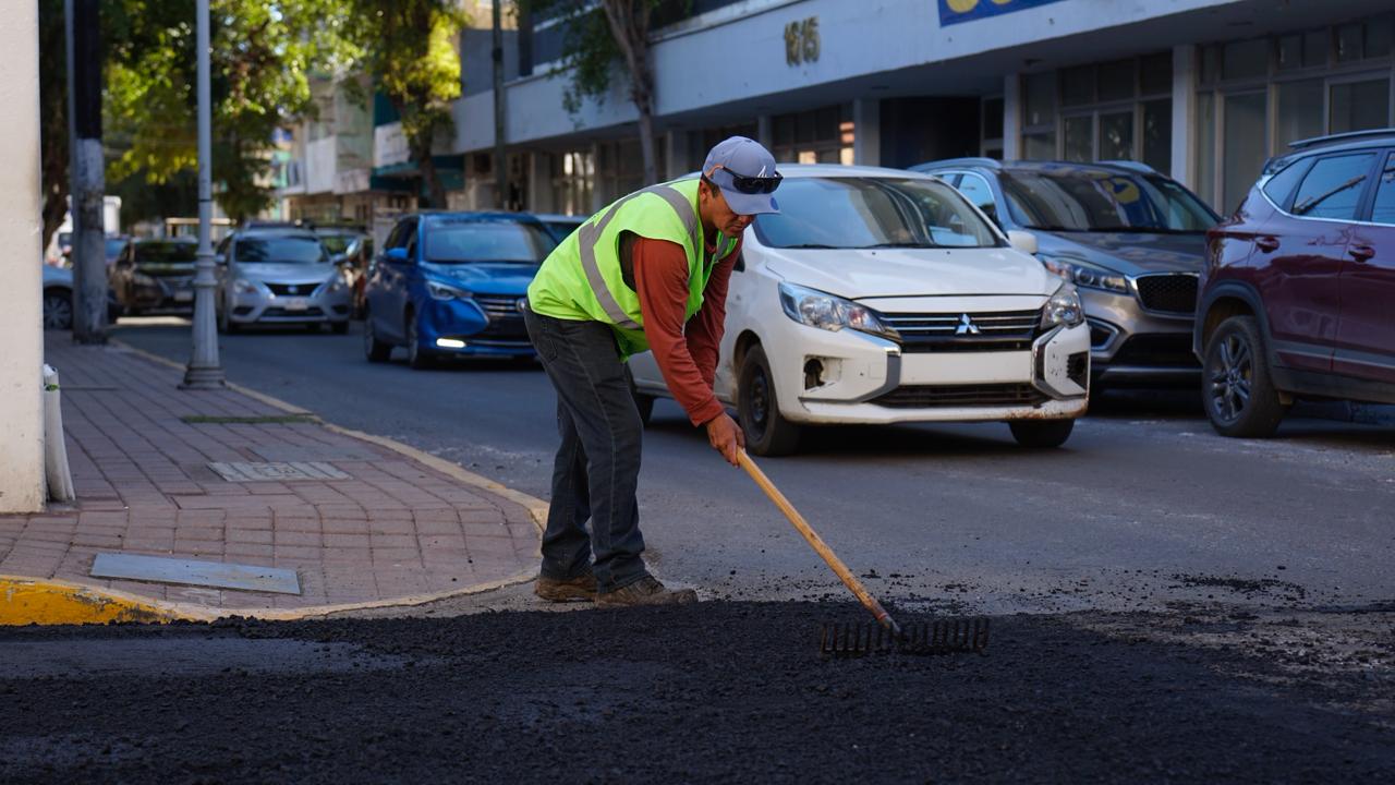 Persona con pala en calle pavimentada